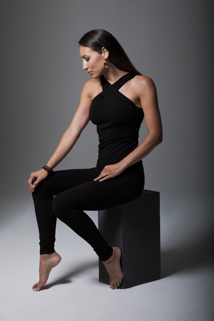 Model sitting and posing in the Renew Ultra High Waist Yoga Legging in black, showcasing the flattering fit and stylish design, perfect for both workouts and casual wear