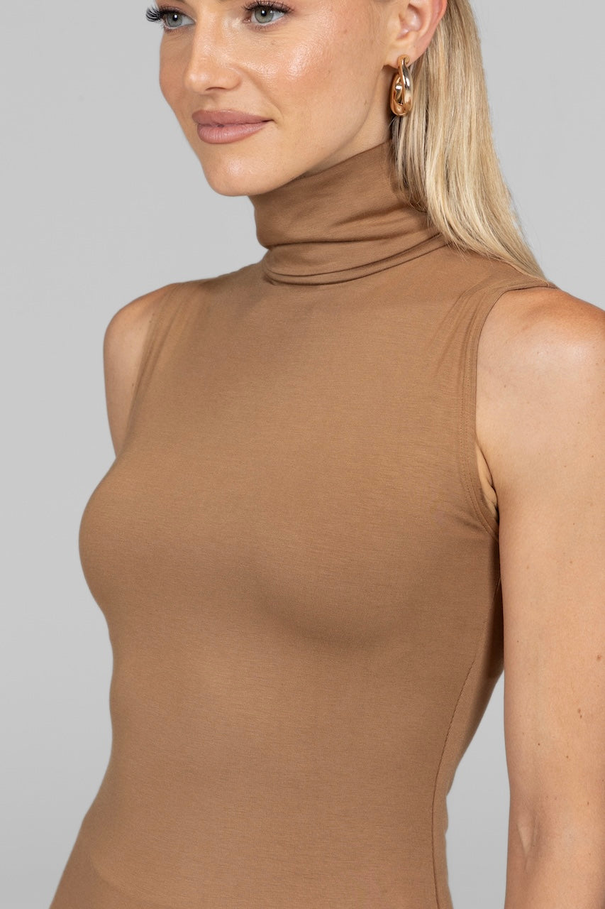 Detailed view of the camel Sleeveless Turtleneck's fabric texture and turtleneck collar.