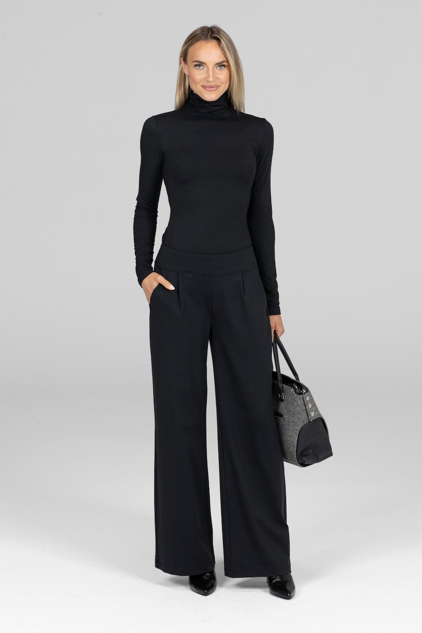 Model wearing black Monica Pant paired with a fitted top for a sophisticated and professional look.