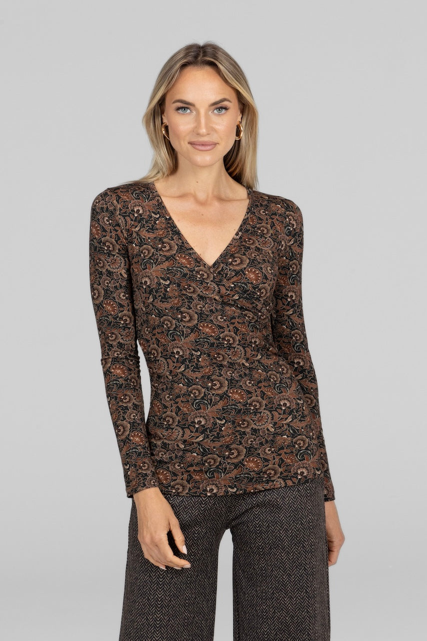 Front view of Ruched Wrap Top in amber floral pattern, highlighting the intricate floral design.